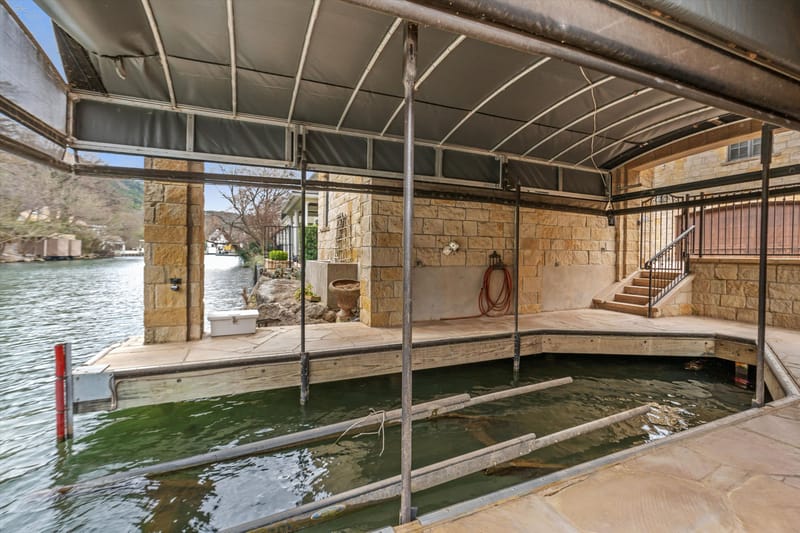 Covered boat dock and slip with lift on Lake Austin
